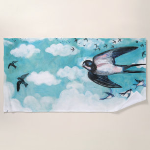 Swallows flying over cloudy blue sky beach towel