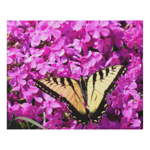 Swallowtail butterfly at garden flowers faux canvas print