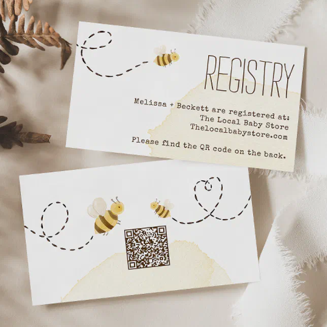 Two cards are placed on top of a satin white fabric, with dried ferns displayed behind them.
