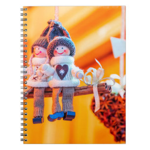 Sweet girl and boy with cinnamon notebook
