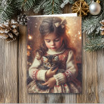Sweet Little Girl and Kitten Christmas Card<br><div class="desc">Cute nostalgic old-fashioned Christmas card. A little girl holding a kitten on a snowy winter night.</div>