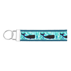 swimming black whales wrist keychain
