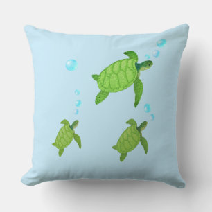Swimming green sea turtles on turquoise throw pillow