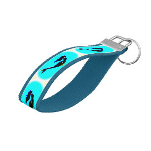 swimming mermaids in blue water l. wrist keychain