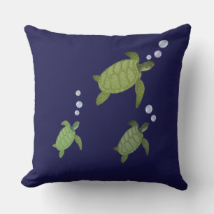 Swimming sea turtles on navy blue throw pillow