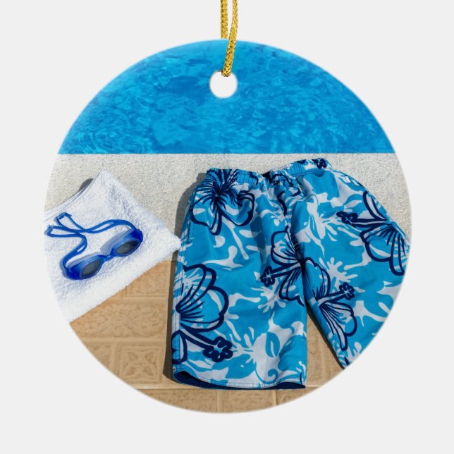 Swimming trunks goggles and towel at pool ceramic ornament (Front)