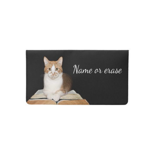 Tabby cat reads checkbook cover