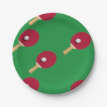 Table tennis racket and ball on green paper plates