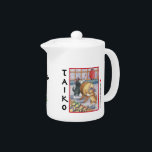 Taiko Cats Teapot<br><div class="desc">Taiko Cats Teapot W/Bud & Tony cats playing the taiko drum wearing ethnic headbands. The word 'Taiko' shown vertically next to illustrated image. Multicolored paw print graphics under spout. For the Asian Cat lover.</div>