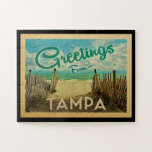 Tampa Beach Vintage Travel Jigsaw Puzzle<br><div class="desc">This Greetings From Tampa vintage postcard design features a sandy beach with a beautiful turquoise ocean water and above the sea,  a blue sky with billowy white clouds. In vintage travels style.</div>