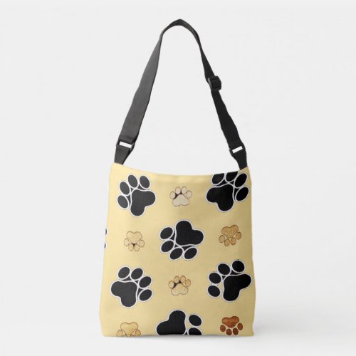 Tan and black paw print on a gold background 3 crossbody bag
