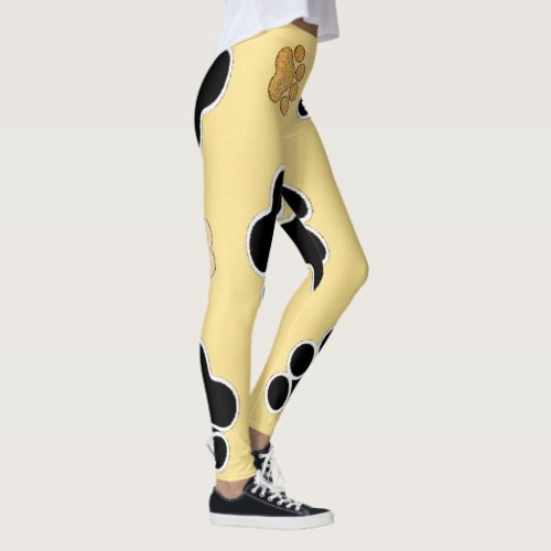 Tan and black paw print on a gold background 3 leggings