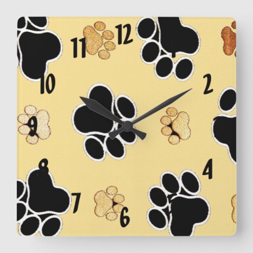 Tan and black paw print on a gold background 3 square wall clock