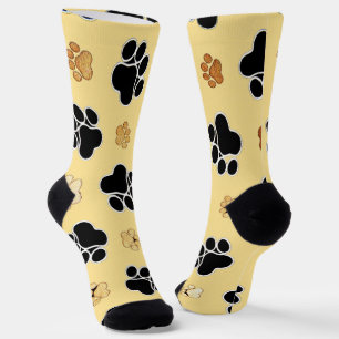 Tan and black paw print on a gold background socks