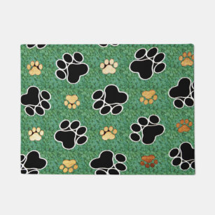 Tan and black paw print on green grass doormat