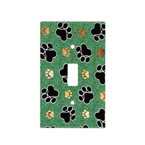 Tan and black paw print on green grass light switch cover