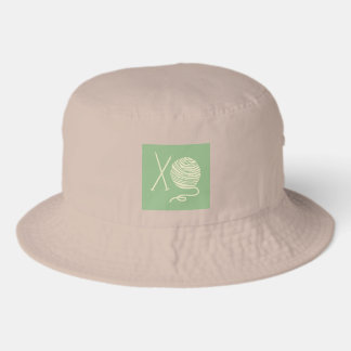 Tan Hat with Knitting Needles and Yarn Ball