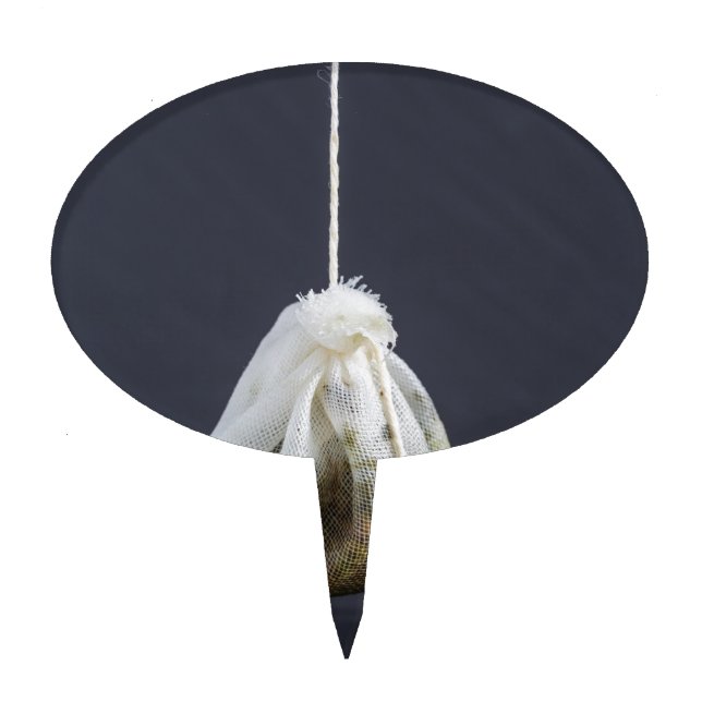 Tea bag is hung in a cup cake topper (Front)