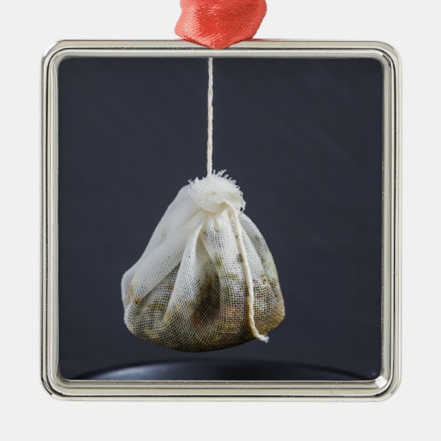 Tea bag is hung in a cup metal ornament (Front)