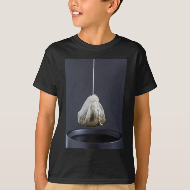 Tea bag is hung in a cup T-Shirt (Front)