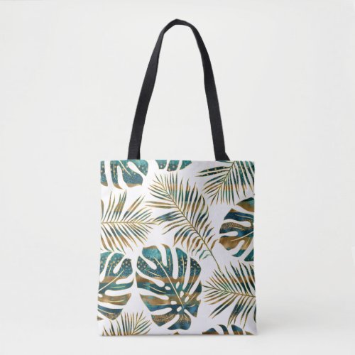 Teal and gold patterned tropical leaves tote bag