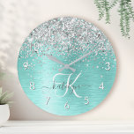 Teal Brushed Metal Silver Glitter Monogram Name Round Clock<br><div class="desc">Easily personalize this trendy chic round clock design featuring pretty silver sparkling glitter on a teal brushed metallic background.</div>