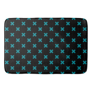 Teal cross stitches on black bath mat
