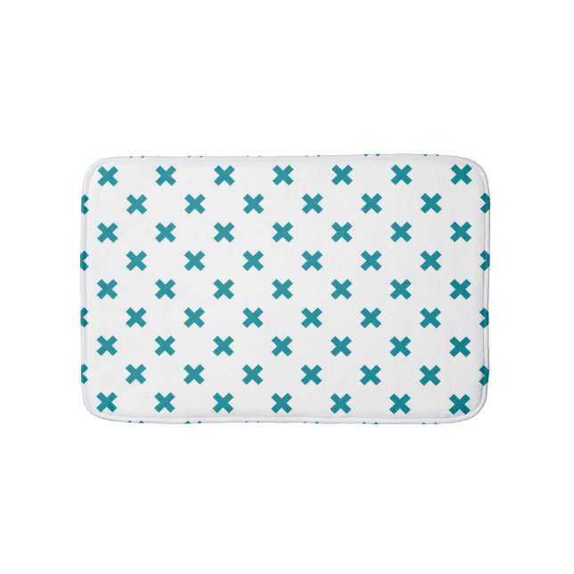 Teal cross stitches on white bath mat (Front)