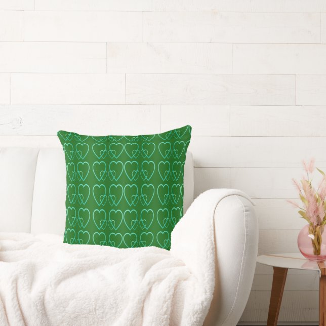 Teal hearts on green throw pillow (Couch)