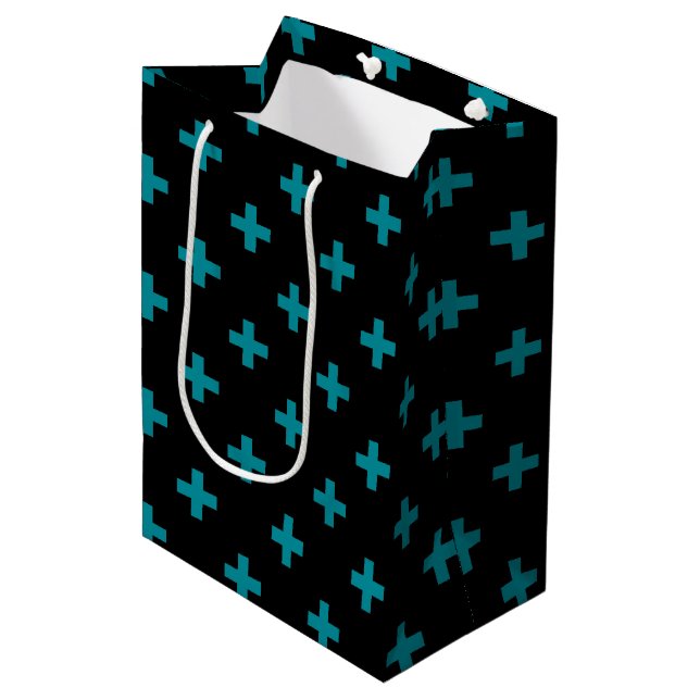 Teal polka crosses on black medium gift bag (Front Angled)