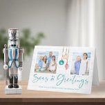 Teal Seas and Greetings Seashell Ornament Photo Holiday Card<br><div class="desc">Seas and Greetings Seashell Ornament Holiday Photo Christmas Cards featuring turquoise teal blue and sandy tan shell ornaments hanging from sailing jute rope with elegant typography against a beachy white wood background. Add two of your photos and a personal message for a fun nautical holiday card. The perfect coastal, beachy...</div>