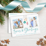 Teal Seas and Greetings Seashell Ornament Photo Holiday Postcard<br><div class="desc">Teal Seas and Greetings Seashell Ornament Photo Cards featuring turquoise teal blue and sandy tan shell ornaments hanging from sailing jute rope with elegant typography against a beachy white wood background. Add two of your photos and a personal message for a fun nautical holiday card. The perfect coastal, beachy feel...</div>