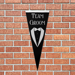 team groom,fun tuxedo with bow black and white pennant flag