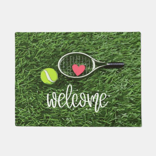 Tennis ball and racket on green welcome doormat