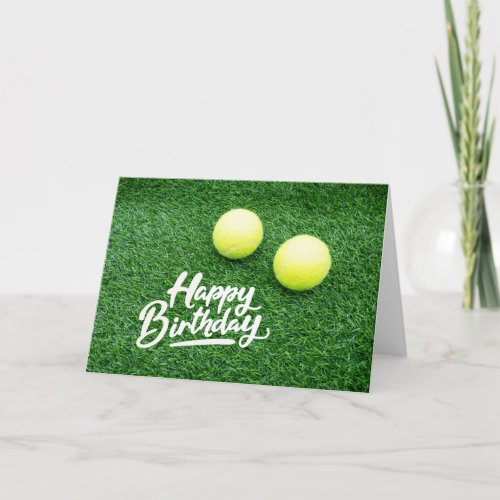 Tennis ball on green grass Happy Birthday Card