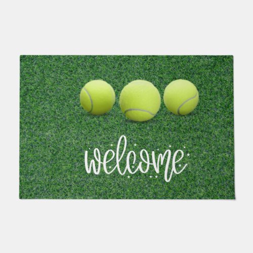 Tennis ball  on green welcome doormat
