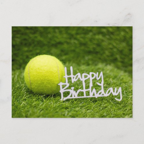 Tennis ball with happy birthday word on green post postcard