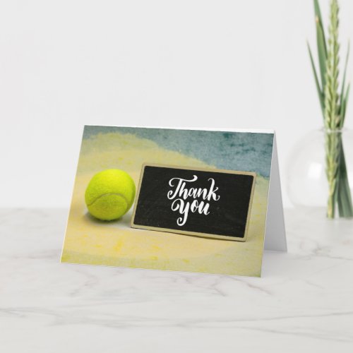 Tennis ball with word thank you on chalk board  ca card