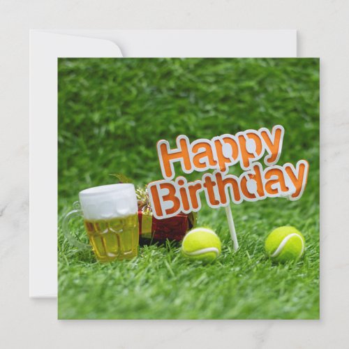 Tennis birthday with ball and gifts on green grass