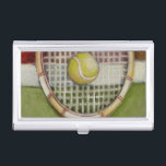Tennis Racket with Ball Laying on Court Business Card Holder<br><div class="desc">Enjoy a little tennis with this scene painted by Ethan Harper. A well stitched racket with a ball sitting on the middle,  you just want to pick it up,  head to your local court and play a game. Purchase your copy of this print today!</div>