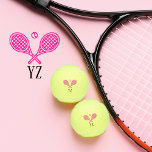 Tennis Theme Pink Girly Monogrammed Name Tennis Balls<br><div class="desc">Single tennis players and doubles teams will love this girly pink tennis themed designed. Modern logo icon style design with two rackets and a ball. Add your initials to create a customized design. Serve up style and personality with these chic, pink monogrammed tennis balls! Ideal for the fashion-forward single player...</div>