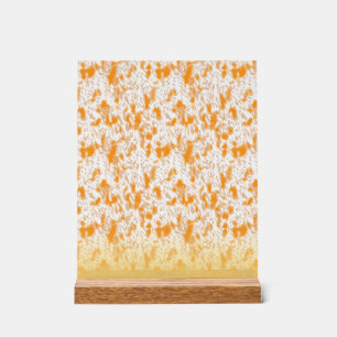 Textile pattern featuring a vibrant orange and gol acrylic sign