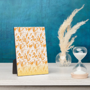 Textile pattern featuring a vibrant orange and gol plaque