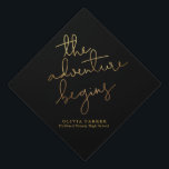 the adventure begins gold black typography graduation cap topper<br><div class="desc">Simple and elegant graduation cap topper featuring a hand lettered typography text in faux gold that says "the adventure begins."  The background is black.</div>