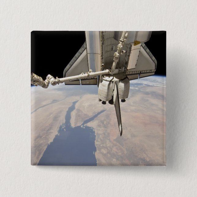 The aft section of the docked space shuttle button (Front)