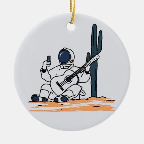 The astronaut is sitting holding a guitar ceramic ornament