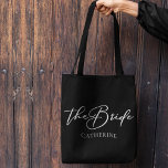 The Bride Personalized Chic Minimalist Wedding Tote Bag<br><div class="desc">This chic,  simple bride black tote bag features your name underneath elegant white typography reading The Bride. Customize these elegant,  modern bridal party gifts for your wedding or bachelorette party.</div>