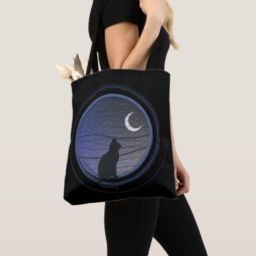 The cat and the moon tote bag