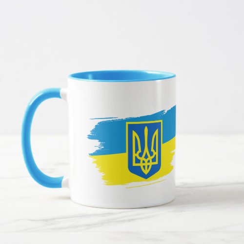 The coat of arms of Ukraine on the state flag Mug