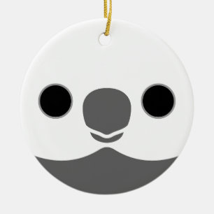 The face of a white-faced male cockatiel ceramic ornament